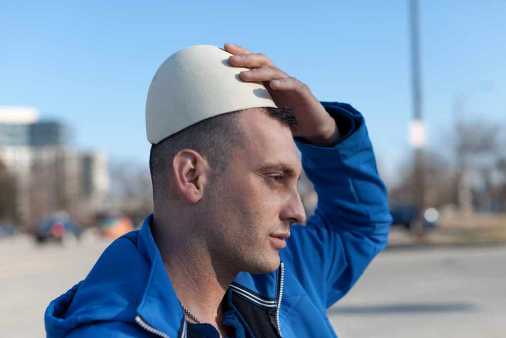     Colin Boyd Shafer, Astrit (Born in Kosovo) wearing a traditional hat called a Plisi, 2014 

