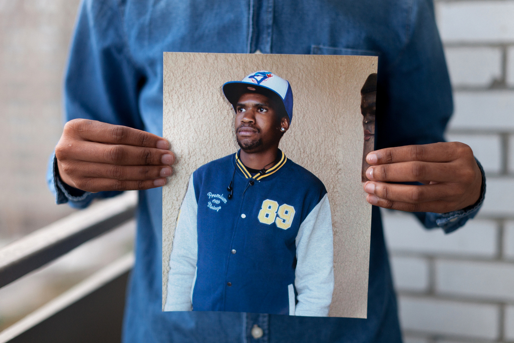     Colin Boyd Shafer, Melvyn (Born in Botswana) holding a photograph of his late brother, 2014 

