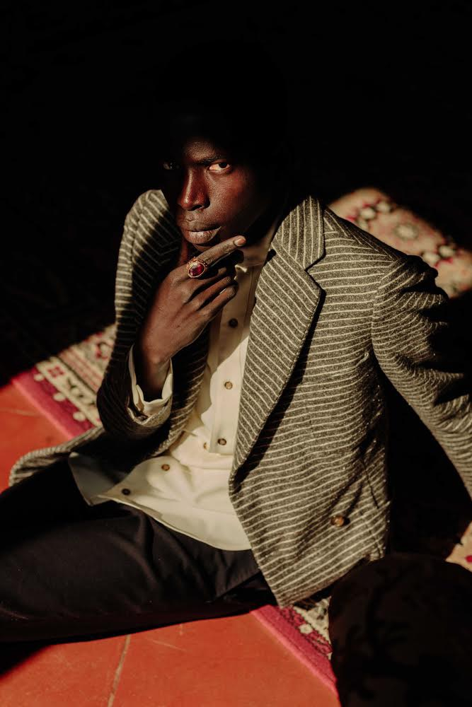    Neil-Anthony Watson, Alieu Kebbeh, a migrant from Gambia sits in an Italian Villa, 2019


